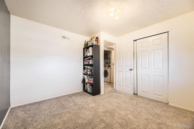 15705 E Brown Ave, Aurora, CO 80013 - unfurnished bedroom featuring carpet, a textured ceiling, washer / dryer, and a closet