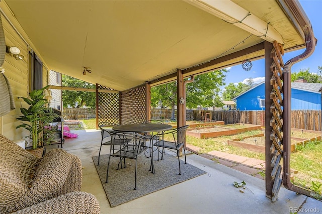 15705 E Brown Ave, Aurora, CO 80013 - fenced backyard featuring a vegetable garden, a patio, and outdoor dining area