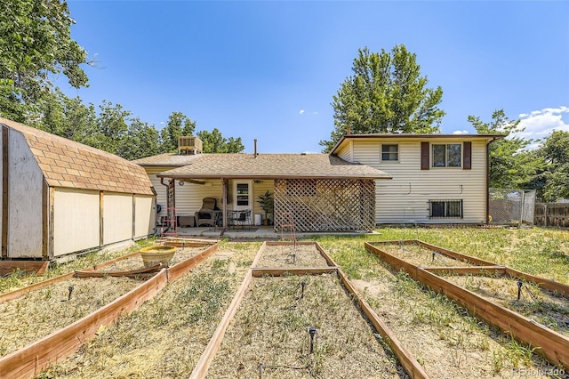 15705 E Brown Ave, Aurora, CO 80013 - back of house featuring a vegetable garden, a storage shed, and a patio area