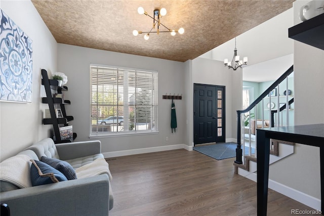 7106 Cerney Cir, Castle Pines, CO 80108 - foyer with plenty of natural light, stairs, a notable chandelier, and dark wood finished floors