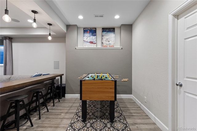 7106 Cerney Cir, Castle Pines, CO 80108 - recreation room with baseboards, a dry bar, wood finished floors, and visible vents