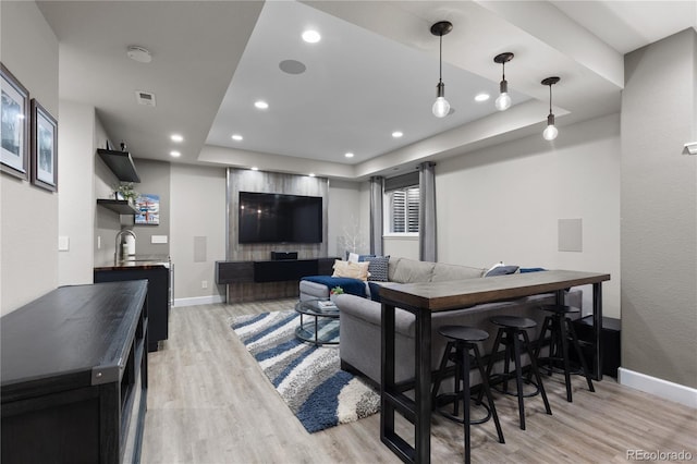 7106 Cerney Cir, Castle Pines, CO 80108 - living area featuring baseboards, indoor wet bar, recessed lighting, and light wood-style flooring