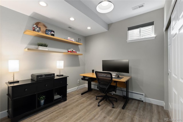7106 Cerney Cir, Castle Pines, CO 80108 - home office with baseboards, a baseboard heating unit, wood finished floors, and visible vents