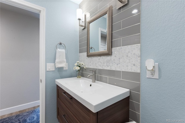 7106 Cerney Cir, Castle Pines, CO 80108 - bathroom featuring vanity, decorative backsplash, and tile walls