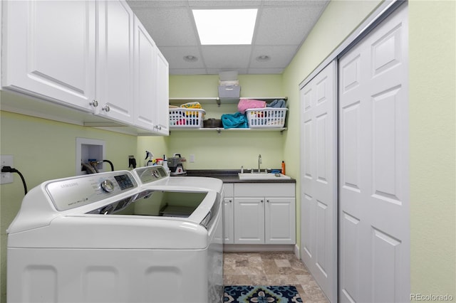 7106 Cerney Cir, Castle Pines, CO 80108 - laundry room featuring a sink, cabinet space, stone finish floor, and washing machine and clothes dryer