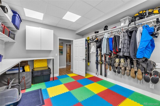 7106 Cerney Cir, Castle Pines, CO 80108 - playroom featuring baseboards and a paneled ceiling