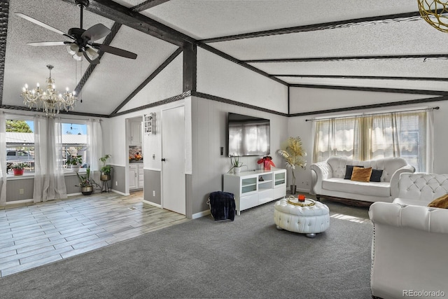 living room featuring ceiling fan with notable chandelier, hardwood / wood-style flooring, lofted ceiling with beams, and a textured ceiling