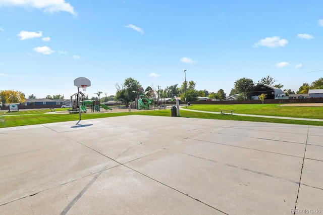 view of sport court featuring a playground and a lawn