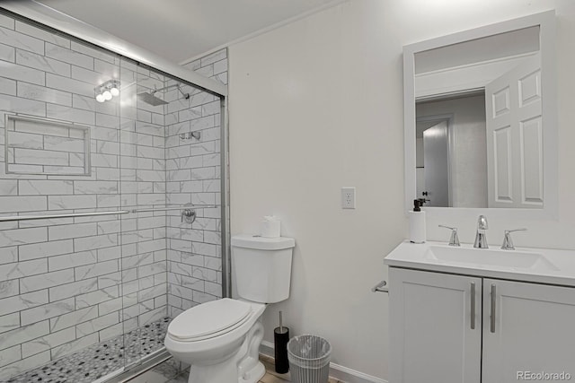 bathroom featuring vanity, toilet, and a shower with door