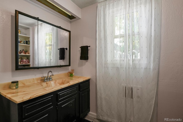 bathroom with vanity and a textured ceiling