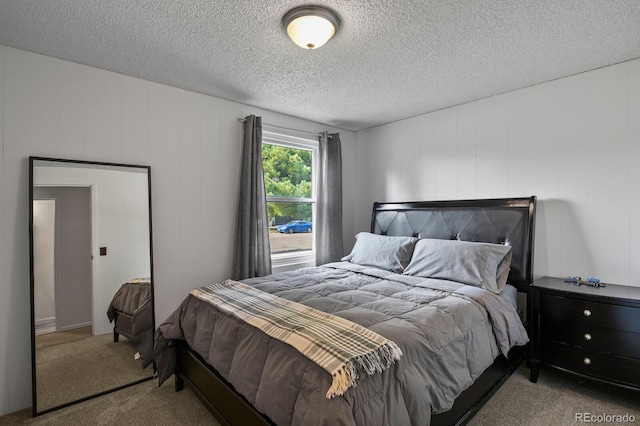 bedroom featuring carpet and a textured ceiling