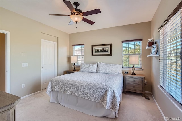 bedroom featuring light carpet and ceiling fan