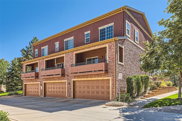 townhome / multi-family property featuring a garage and a balcony