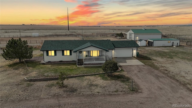 32350 E 137th Way, Brighton, CO 80603 - ranch-style house with dirt driveway, a garage, fence, and a porch