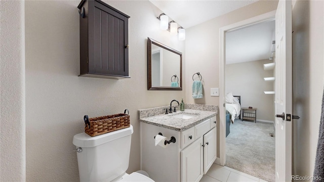 32350 E 137th Way, Brighton, CO 80603 - ensuite bathroom featuring toilet, vanity, tile patterned flooring, and baseboards