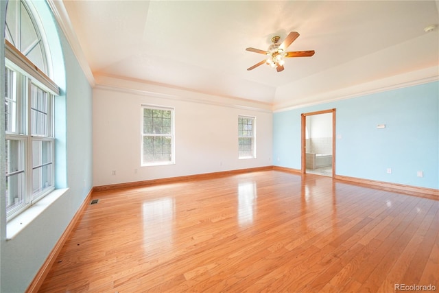 empty room featuring ceiling fan, crown molding, and light wood-type flooring