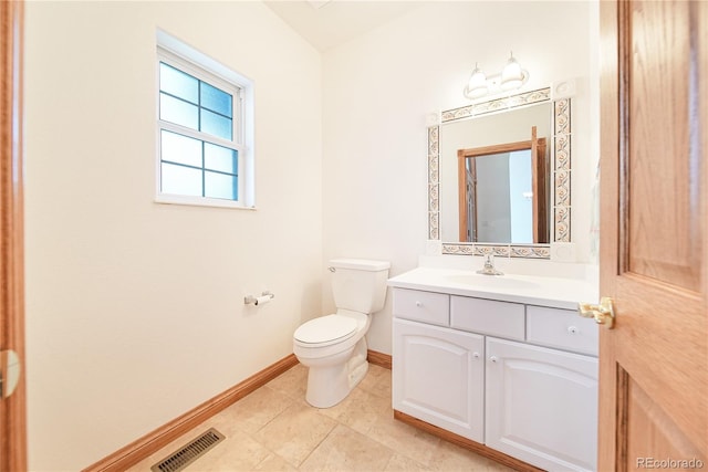 bathroom with vanity, tile patterned floors, and toilet