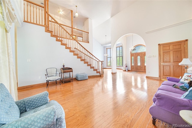 living room featuring a towering ceiling and wood-type flooring