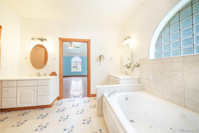 bathroom featuring vanity and a washtub