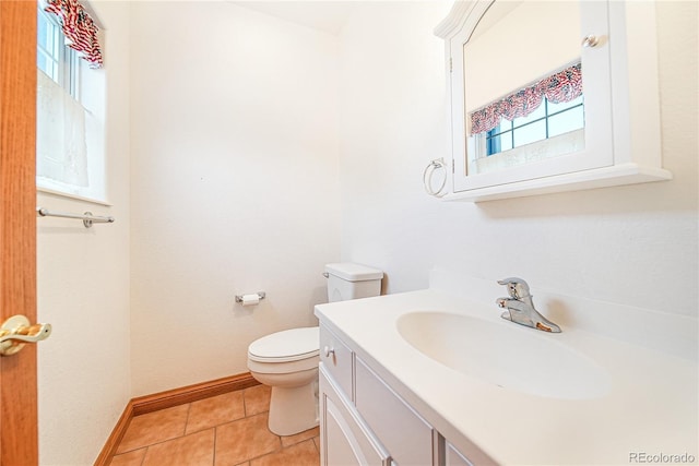 bathroom featuring vanity, tile patterned floors, and toilet