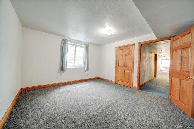 carpeted spare room with a textured ceiling