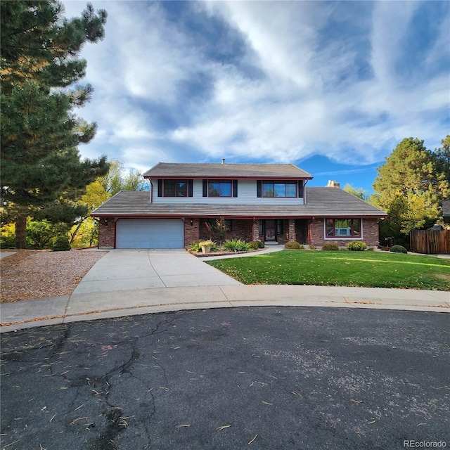 view of front of home with a front yard and a garage