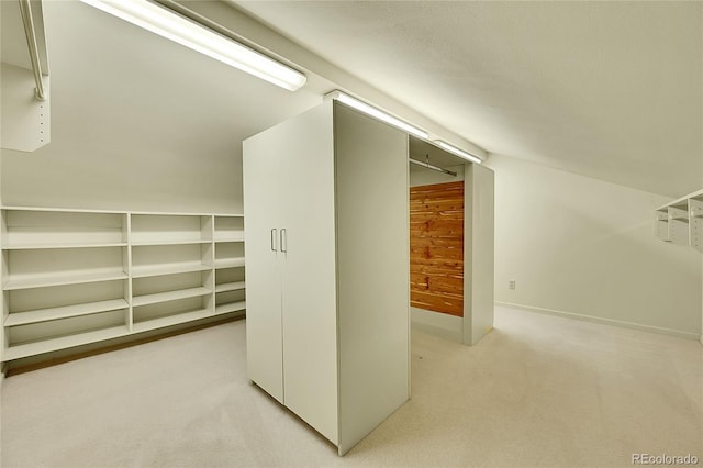 interior space with light carpet and lofted ceiling