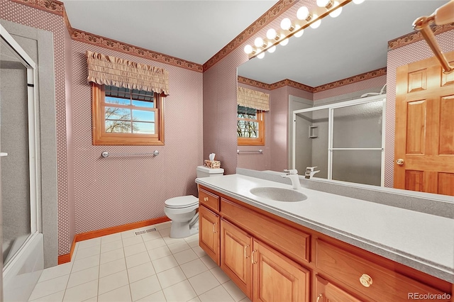 full bathroom with tile patterned flooring, vanity, toilet, and bath / shower combo with glass door