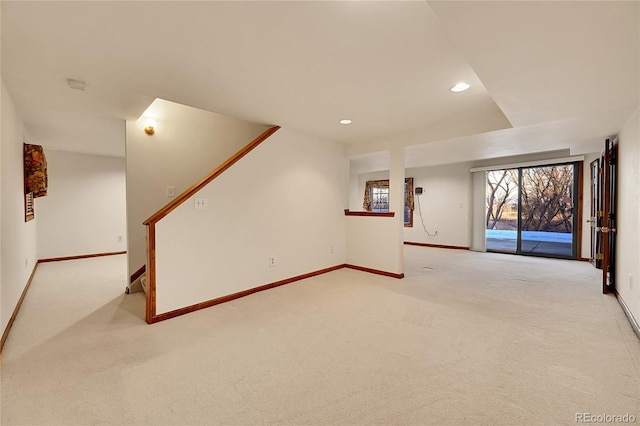 unfurnished living room with light colored carpet