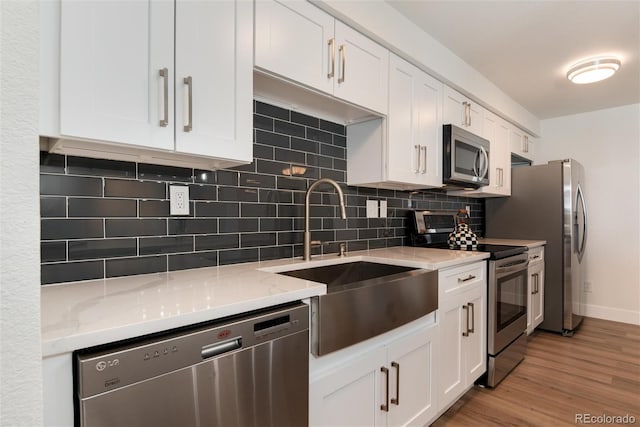 2 Adams St Unit 1504, Denver, CO 80206 - kitchen with appliances with stainless steel finishes, white cabinets, and decorative backsplash