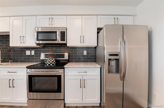 2 Adams St Unit 1504, Denver, CO 80206 - kitchen with stainless steel appliances, white cabinetry, and light countertops