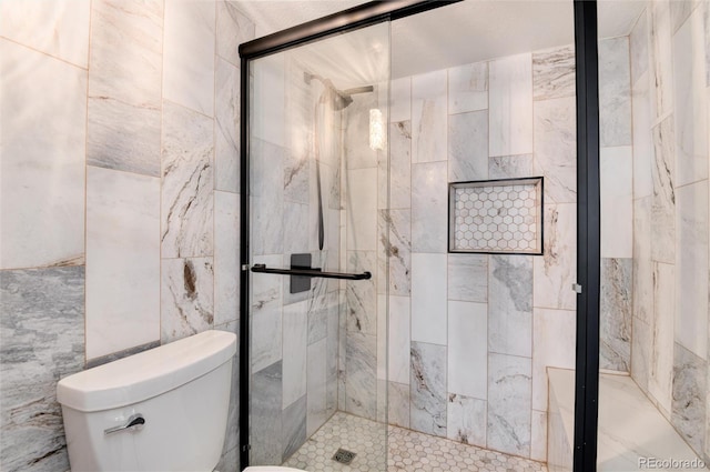 2 Adams St Unit 1504, Denver, CO 80206 - bathroom featuring a stall shower and tile walls