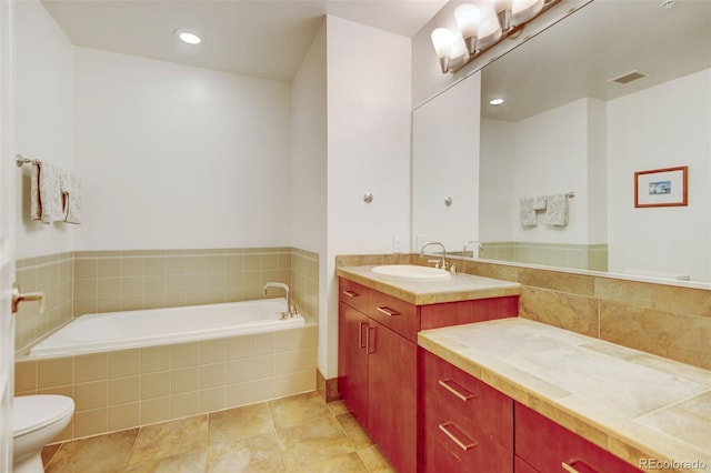 bathroom featuring toilet, visible vents, a bath, tile patterned floors, and vanity