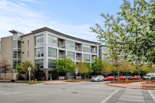 view of building exterior featuring uncovered parking
