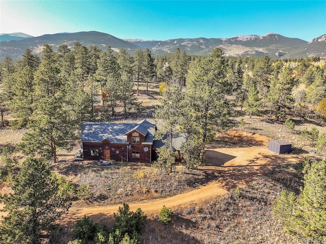 aerial view with a wooded view and a mountain view