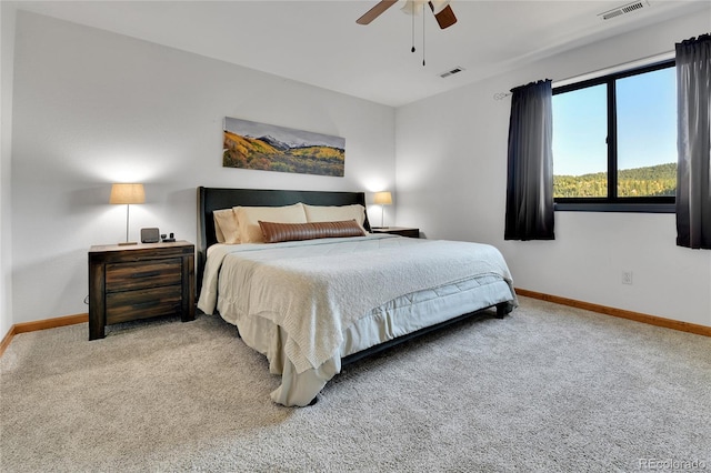 bedroom with light carpet, visible vents, and baseboards