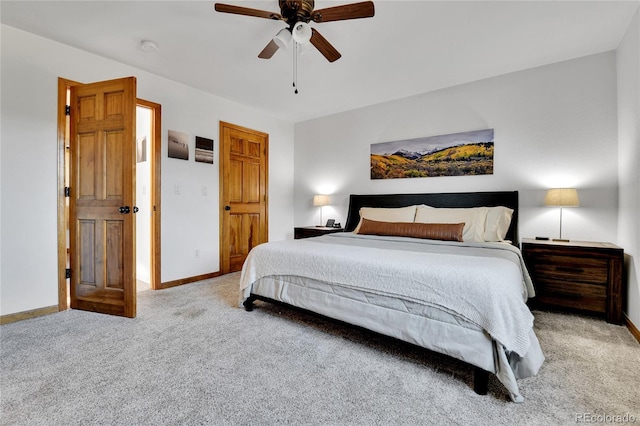 bedroom featuring baseboards, light colored carpet, and ceiling fan