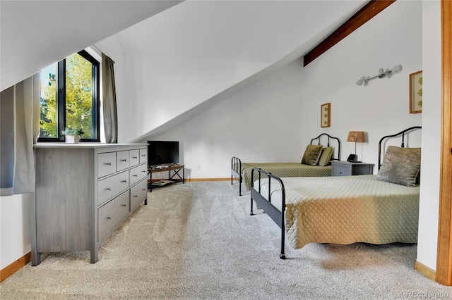 carpeted bedroom with lofted ceiling with beams and baseboards