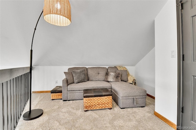 carpeted living area featuring lofted ceiling and baseboards