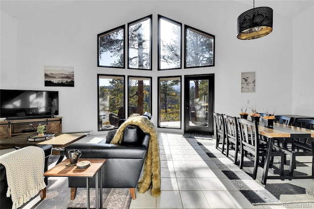 living room featuring tile patterned floors and a high ceiling