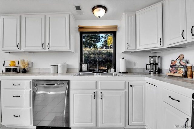 kitchen with visible vents, white cabinetry, a sink, light countertops, and stainless steel dishwasher