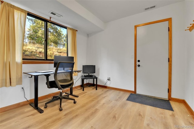 office featuring visible vents, baseboards, and wood finished floors