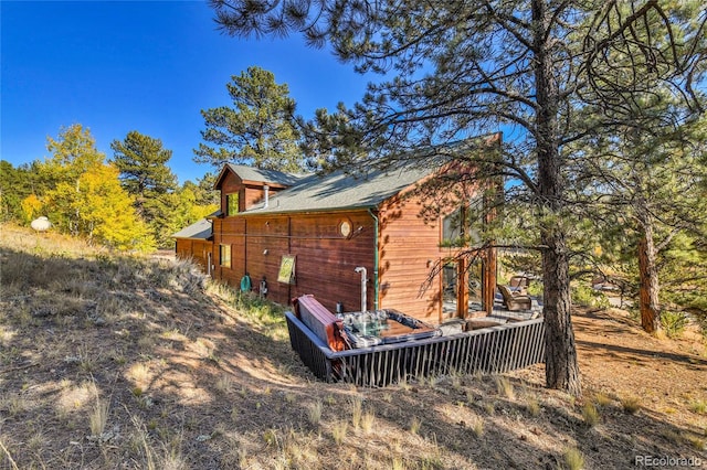 view of property exterior with a deck