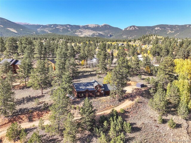 aerial view featuring a mountain view and a wooded view