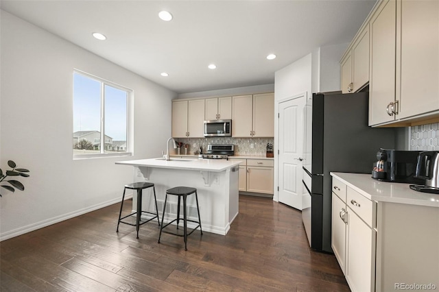 13108 Stoney Meadows Way, Peyton, CO 80831 - kitchen featuring appliances with stainless steel finishes, a breakfast bar, tasteful backsplash, light countertops, and recessed lighting