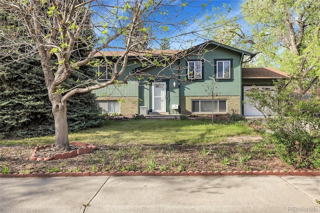 split foyer home with brick siding and a front yard