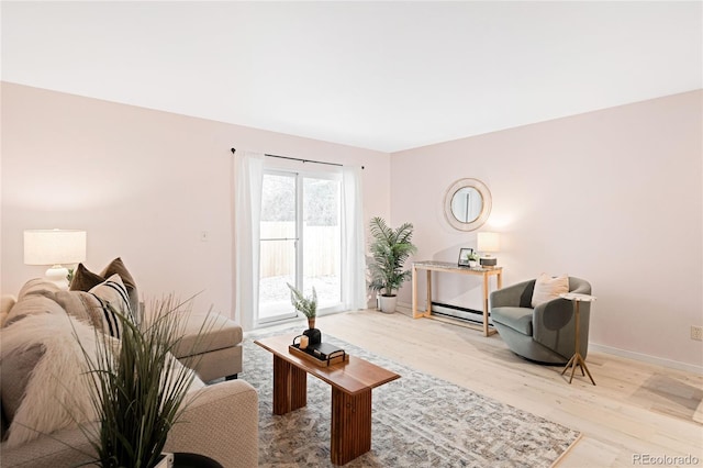 living area featuring light wood-style flooring and baseboards