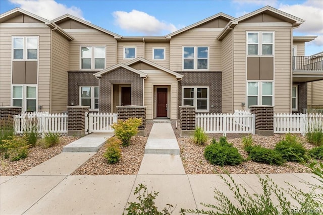15492 W 65th Ave Unit C, Arvada, CO 80007 - view of front facade featuring a fenced front yard and brick siding