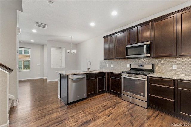 15492 W 65th Ave Unit C, Arvada, CO 80007 - kitchen with stainless steel appliances, dark wood-type flooring, decorative backsplash, and recessed lighting