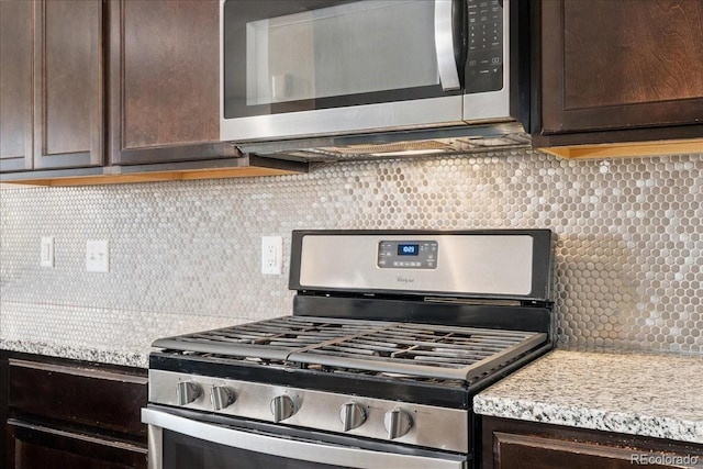 15492 W 65th Ave Unit C, Arvada, CO 80007 - kitchen with stainless steel appliances, dark brown cabinetry, and backsplash